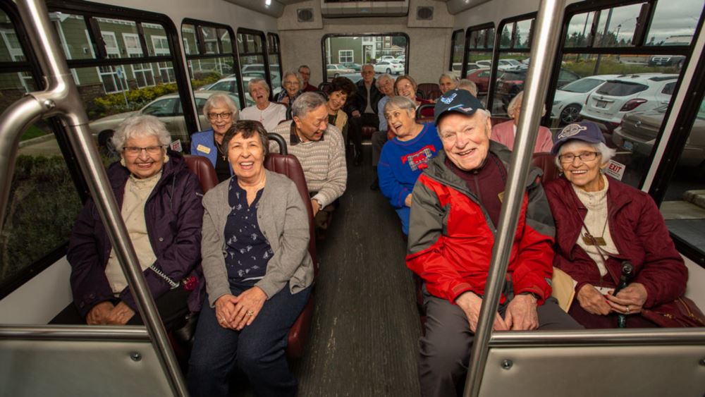 Fairview Estates happy seniors on a bus.